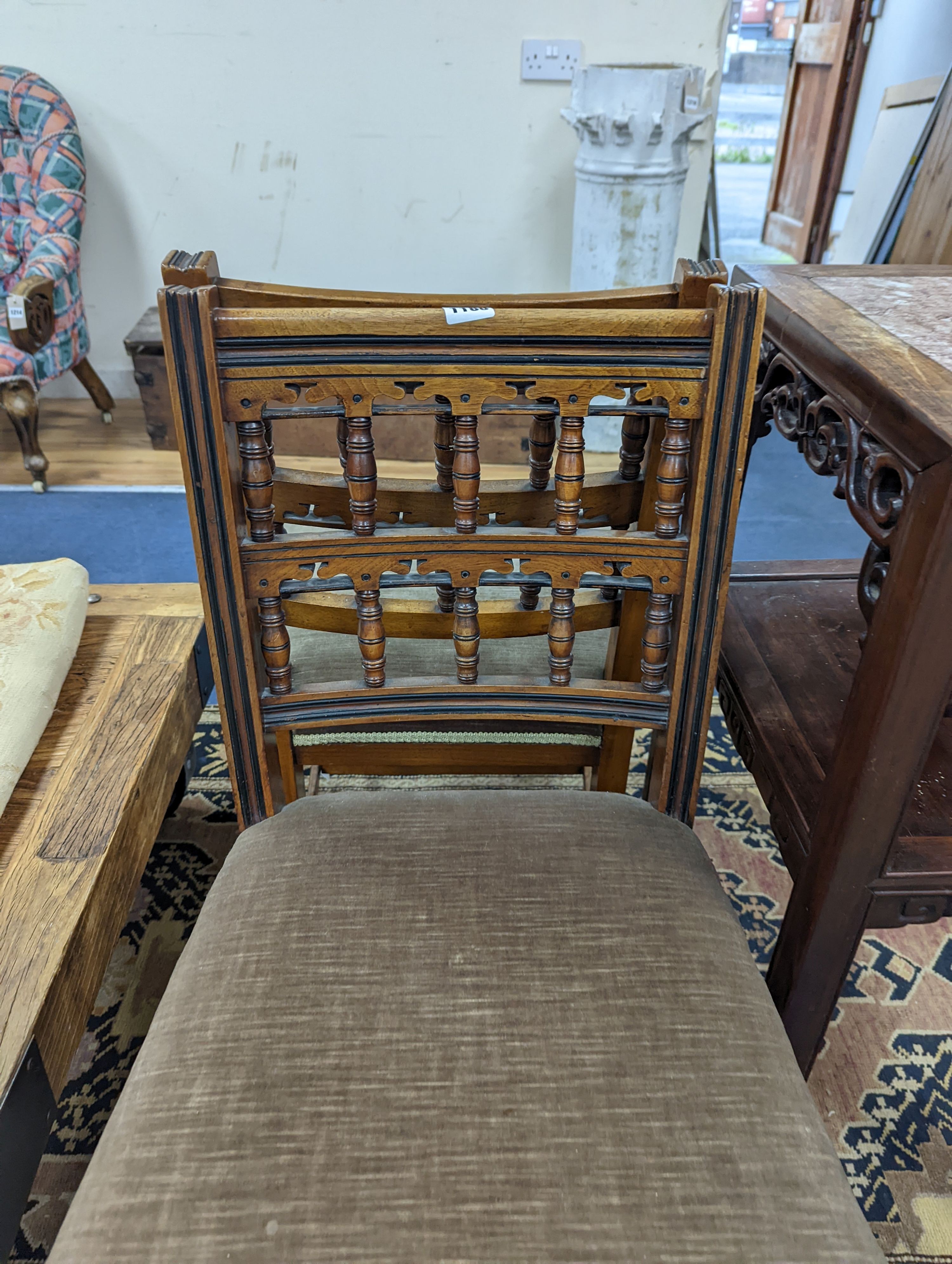 Bruce James Talbert (1838-1881) for James Lamb, Manchester, a pair of Aesthetic movement walnut side chairs, width 44cm, depth 48cm, height 82.5cm